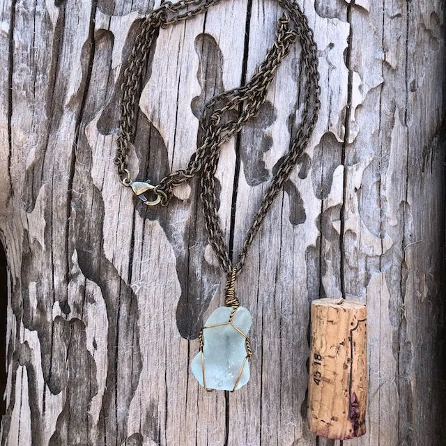 Bronze wire-wrapped sea glass pendant on bronze double chain