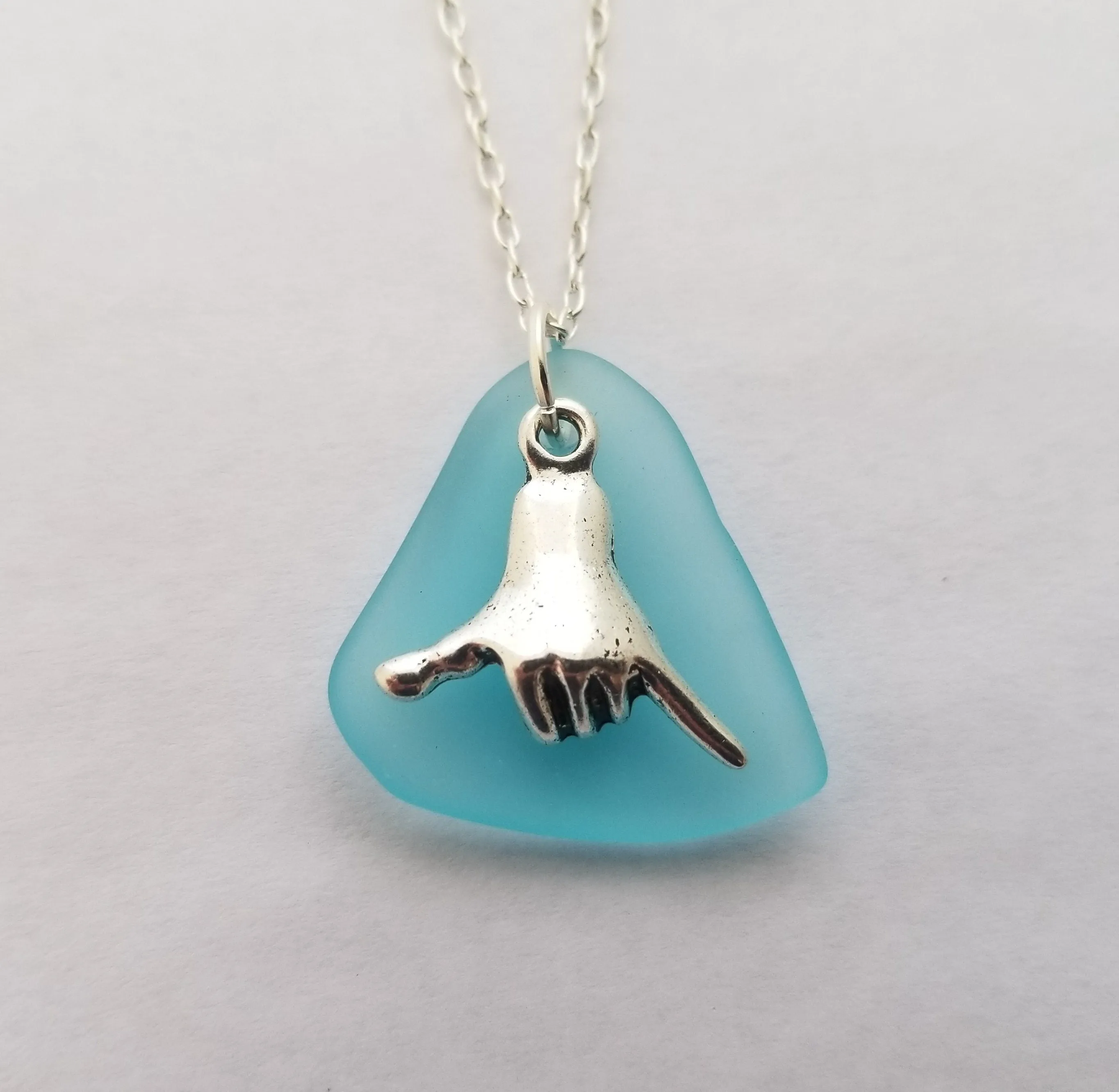Handmade in Hawaii, Hawaii culture "Shaka - carefree attitude" sign, Turquoise Bay blue sea glass necklace, "December Birthstone" color